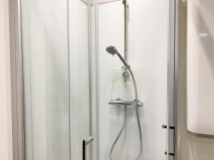 a shower in a bathroom with a glass door at Monet - appartement pour 2 personnes in Chartres +2 photos