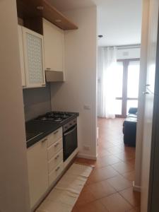 a kitchen with white cabinets and a stove top oven at Rox Apartment - 027023-LOC-00174 in Mira