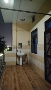 a bathroom with a sink in a room at Happy family homestay in Ayodhya