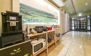a room with a television and a mural on the wall at Cheongju Ochang memory stay in Cheongju