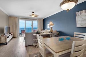 a dining room and living room with a dining table at Grandview East 1204 in Panama City Beach