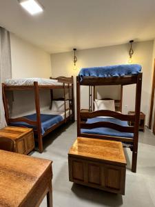 a room with three bunk beds in a room at POUSADA PONTA DA ASA in Coruripe