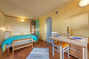 a bedroom with a bed and a table and chairs at Studio vue sur mer in Plomodiern