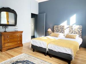 a bedroom with a bed with a mirror and a dresser at Van Gogh in Chartres