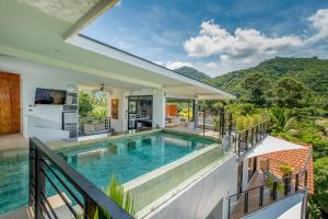 a swimming pool on the balcony of a house at Penthouse Crystal Bay Apartments in Ban Lamai