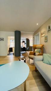 a living room with a couch and a table at ApartmentInCopenhagen Apartment 1580 in Copenhagen