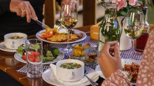 a table with plates of food and glasses of wine at penzion Dvorce in Třeboň