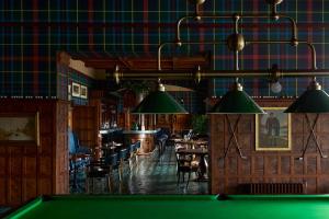 a pool table in a pub with tables and chairs at Dornoch Station in Dornoch