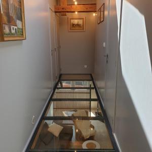 a hallway with a glass floor with a fish in it at Résidence du mini jardin in Martelange