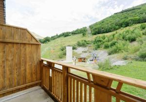 a wooden balcony with a view of a mountain at Résidence Routes du Monde ATC Saint-François-Longchamp in Saint-François-Longchamp