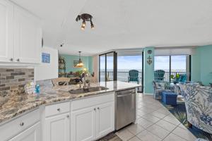 a kitchen with a sink and a view of the ocean at AquaVista Resort 805-W By Book That Condo in Panama City Beach