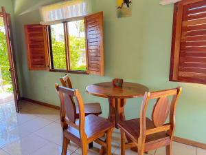 jadalnia z drewnianym stołem i krzesłami w obiekcie Montefresco Boutique Hostel w mieście Monteverde