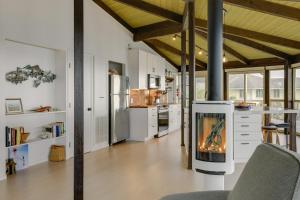 a kitchen with a fireplace in the middle of a room at Serene Irish Beach Home with Panoramic Ocean Views! in Manchester