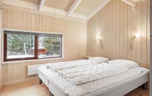 a large white bed in a room with a window at Nice Home In Fjerritslev With Sauna in Fjerritslev