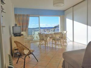 a living room with a table and chairs and a balcony at Appartement Le Lavandou, 2 pièces, 4 personnes - FR-1-251-345 in Le Lavandou