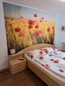 un dormitorio con una pintura de amapolas rojas en Frühstückspension Eibenstein, 