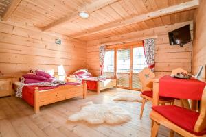a bedroom with two beds in a log cabin at Domek u Horarów in Ciche