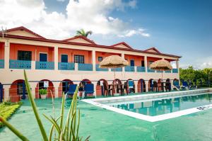 a resort with a swimming pool with chairs and umbrellas at Waterloo Guest House in Black River