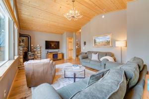 a living room with a couch and a table at Tahoe Donner Mountain Cabin Surrounded by Forest! in Truckee