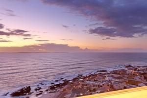 an aerial view of a beach at sunset at Blouberg Heights 1608 by HostAgents in Bloubergstrand