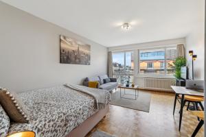 a bedroom with a bed and a living room at Athénée 36 Résidence by Homenhancement in Geneva