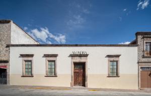 a white building with a sign that reads morgan at Casa Alondra in Morelia