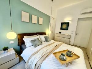 a bedroom with a large bed with a table on it at [Porta Nuova - Alpitour] Free Parking & Netflix in Turin