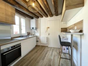 a kitchen with a sink and a counter top at L'Eure Tranquille in Chartres