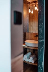 a bathroom with a sink and a counter with towels at Apartamenty Morska 92 in Sasino