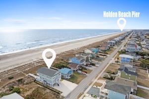 an aerial view of a beach with houses at Fish-N-Chips by the Sea home in Holden Beach