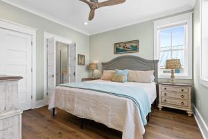 a bedroom with a large bed and a window at Fish-N-Chips by the Sea home in Holden Beach