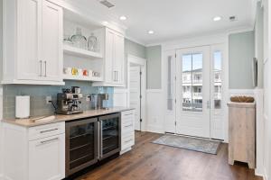 a kitchen with white cabinets and a counter top at Fish-N-Chips by the Sea home in Holden Beach