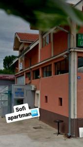 a sign in front of a building that says soft apartment at Sofi II in Niš