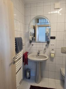 a bathroom with a sink and a mirror at Ferienwohnung Augustin in Kirchberg