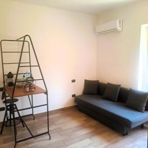 a living room with a blue couch and a ladder at Edoardoapartments in Vercelli