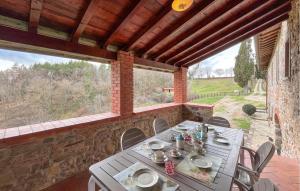 a table and chairs in a room with a large window at Awesome Home In Bibbiena With Kitchen in Bibbiena