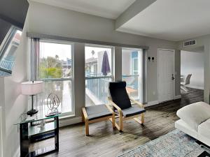 a living room with a chair and a balcony at Madeira Beach Yacht Club 247g in St Pete Beach