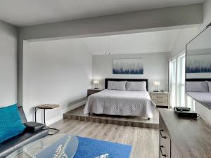 a bedroom with a bed and a tub in it at Madeira Beach Yacht Club 247g in St. Pete Beach