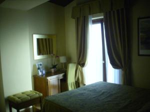 Кровать или кровати в номере Chiara e Benedetta Villa degli Ulivi
