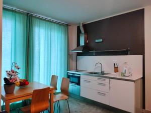 a kitchen with a table and a dining room at Residence Igea in Rimini