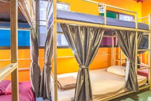 a room with bunk beds in a hostel at OYO 586 I Hostel in Phuket