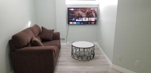 a living room with a couch and a table at 2 Bedroom Luxury Apartment in Guelph
