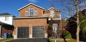 a brick house with a two car garage at 2 Bedroom Luxury Apartment in Guelph