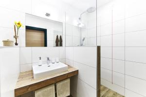 a white bathroom with a sink and a mirror at Krumbacherhof in Krumbach Markt