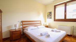 a bedroom with a bed with two towels on it at Villino Octagon in Elmas