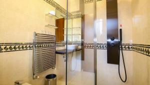 a bathroom with a sink and a mirror at Villino Octagon in Elmas +21 photos