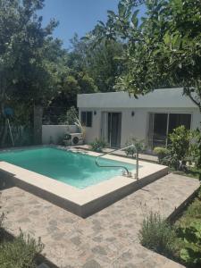 a swimming pool in a yard with a house at Colonia in Colonia del Sacramento +7 photos