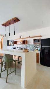a kitchen with a large white table and chairs at Casa GAIA - Punta Sal in Canoas De Punta Sal