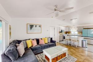 a living room with a couch and a kitchen at Endless Summerland in Summerland Key