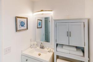 a white bathroom with a sink and a mirror at Endless Summerland in Summerland Key